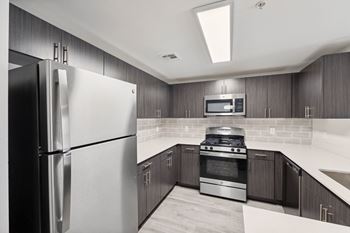 a kitchen with stainless steel appliances and wooden cabinets